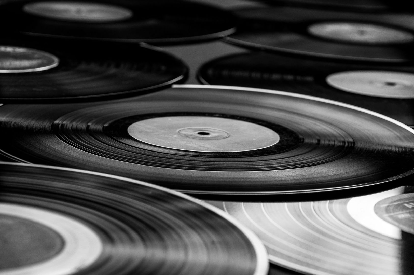 Black-and-white close-up of overlapping vinyl records and grooves
